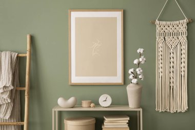 Stylish living room interior design with mock up poster frames, macrame, wooden chest of drawers, beige vase and creative home accessories. Sage green wall. Template. 