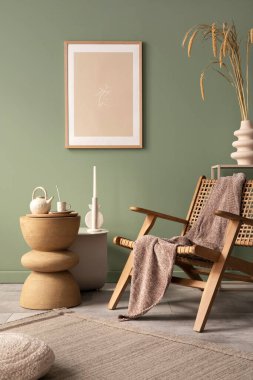 Stylish living room interior design with mock up poster frames, rattan armchair, coffe table, beige carpet and creative home accessories. Sage green wall. Template. 