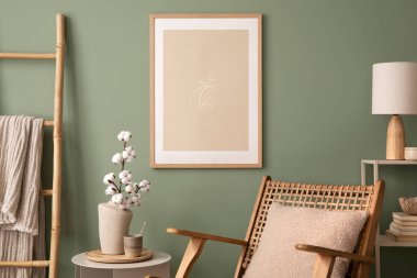 Stylish living room interior design with mock up poster frames, rattan armchair, coffe table, beige carpet and creative home accessories. Sage green wall. Template. 