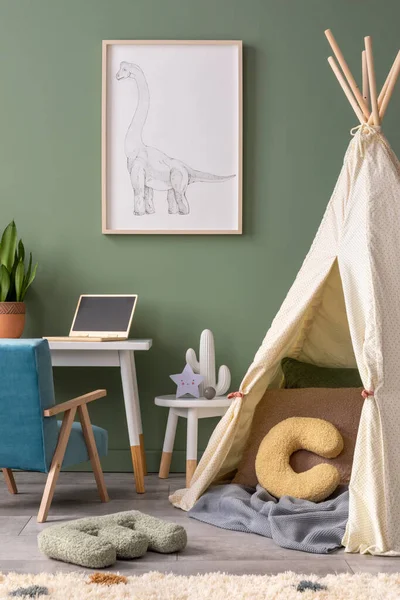 Stylish composition of cozy child room interior design with green wall with poster and armchair. Desk with computer and plant. Mock up poster. Pillow and bright carpet. Hut with pillows and plaid.