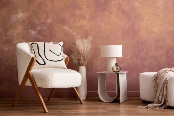 The stylish composition a living room interior with copy space white armchair, coffee table, lamp, vase with dried flowers and personal accessories. Home decor. Template.