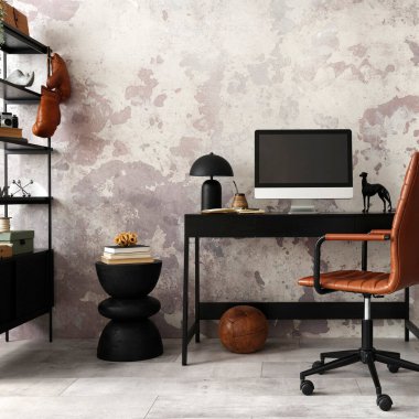 Concrete interior of home office with black desk, brown armchair, computer screen, office accessories and lamp. Rack with personal accessories. Home decor. Template. 