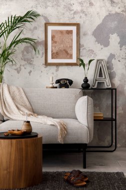 The stylish compostion at living room interior with design gray sofa, armchair, woooden coffee table, lamp and elegant personal accessories. Loft and industrial interior. Template. 