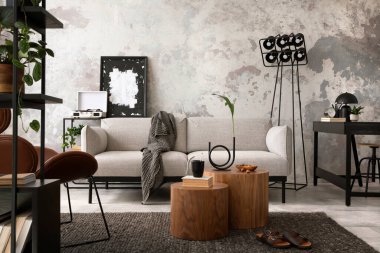 The stylish compostion at living room interior with design gray sofa, wooden coffee table, brown armchair and elegant personal accessories. Loft and industrial interior. Home decor. Template.