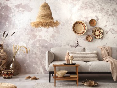 The stylish ethnic composition at living room interior with grey sofa, colorful wicker, straw lamp, bench and elegant personal accessories. Grey concrete wall. Cozy apartment. Home decor. 