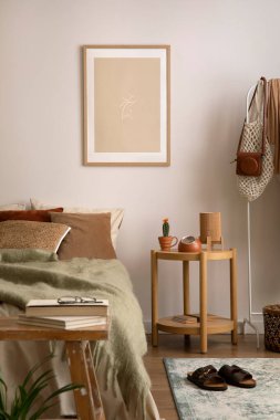 Stylish composition of cozy bedroom with mock up, beige bedding, and wooden coffee table. Mock up poster with wooden frame. Home decor. Template. 