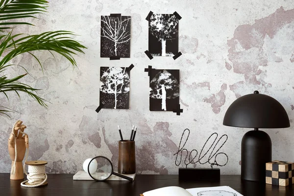 Concrete interior of home office with black desk, office accessories, image. Rack with personal accessories. Home decor. Template.