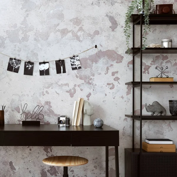 Concrete interior of home office with black desk,  black and white image, office accessories and plants. Rack with personal accessories. Home decor. Template.