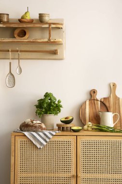 Interior design of kitchen space with rattan commode,  chair, herbs, vegetables, food and kitchen accessories in modern home decor.  Template. 