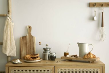 Interior design of kitchen space with rattan commode,  ladder, baking, food and kitchen accessories in modern home decor.  Template. 