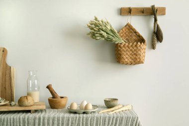 Interior design of kitchen space with table with tablecloth, ladder, bread, herbs, food and kitchen accessories in modern home decor.  Template. 