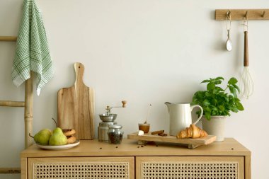 Interior design of kitchen space with rattan commode,  ladder, pears, food and kitchen accessories in modern home decor.  Template.