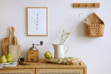 Interior design of kitchen space with rattan commode,  chair, herbs, vegetables, food and kitchen accessories in modern home decor. Mock up poster. Template. 