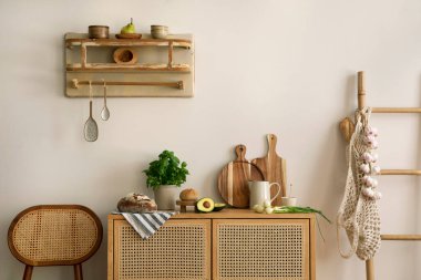 Interior design of kitchen space with rattan commode and chair,  ladder, herbs, vegetables, food and kitchen accessories in modern home decor.  Template. 
