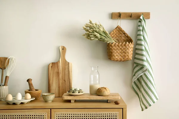 Interior design of kitchen space with rattan commode,  chair, herbs, vegetables, food and kitchen accessories in modern home decor. Template. 