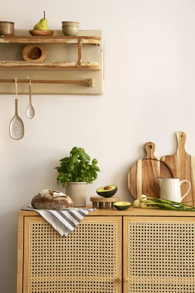 Interior design of kitchen space with rattan commode,  chair, herbs, vegetables, food and kitchen accessories in modern home decor.  Template. 