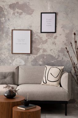The stylish compostion at living room interior with design gray sofa, coffee table, posters and elegant personal accessories. Loft and industrial interior. Mock up poster. Template. 
