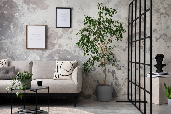The stylish compostion at living room interior with design gray sofa, coffee table, plant, hanger, lamp and elegant personal accessories. Loft and industrial interior. Moc up poster. Template.