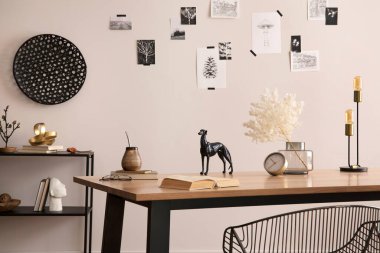 The stylish composition of cozy office interior with metal chair, wooden table, plants poster and personal accessories. Home decor. Template. 