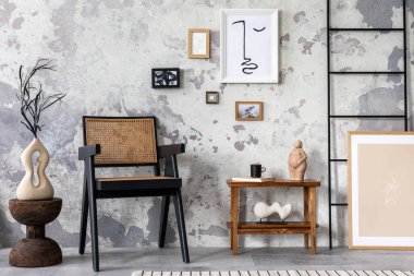 The stylish composition of living room interior with mock up, rattan chair, wooden coffee table and personal accessories. Mock up poster. Home decor. Template. 