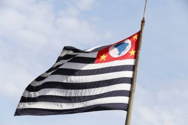 Sao Paulo state flag fluttering in the wind with the sky in the background
