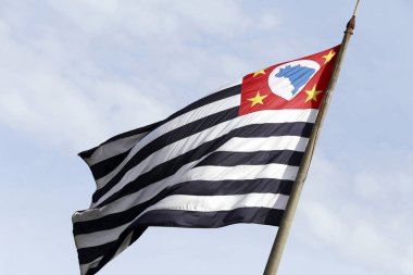 Sao Paulo state flag fluttering in the wind with the sky in the background