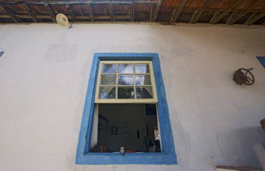 Closeup of colonial blue window in white wall, typical in Brazilian old farms. Sao Paulo state, Brazil
