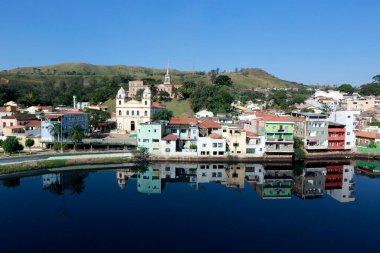 Houses and churches of Pirapora do Bom Jesus city, reflected in the blue waters of the Tiete River. Sao Paulo state, Brazil