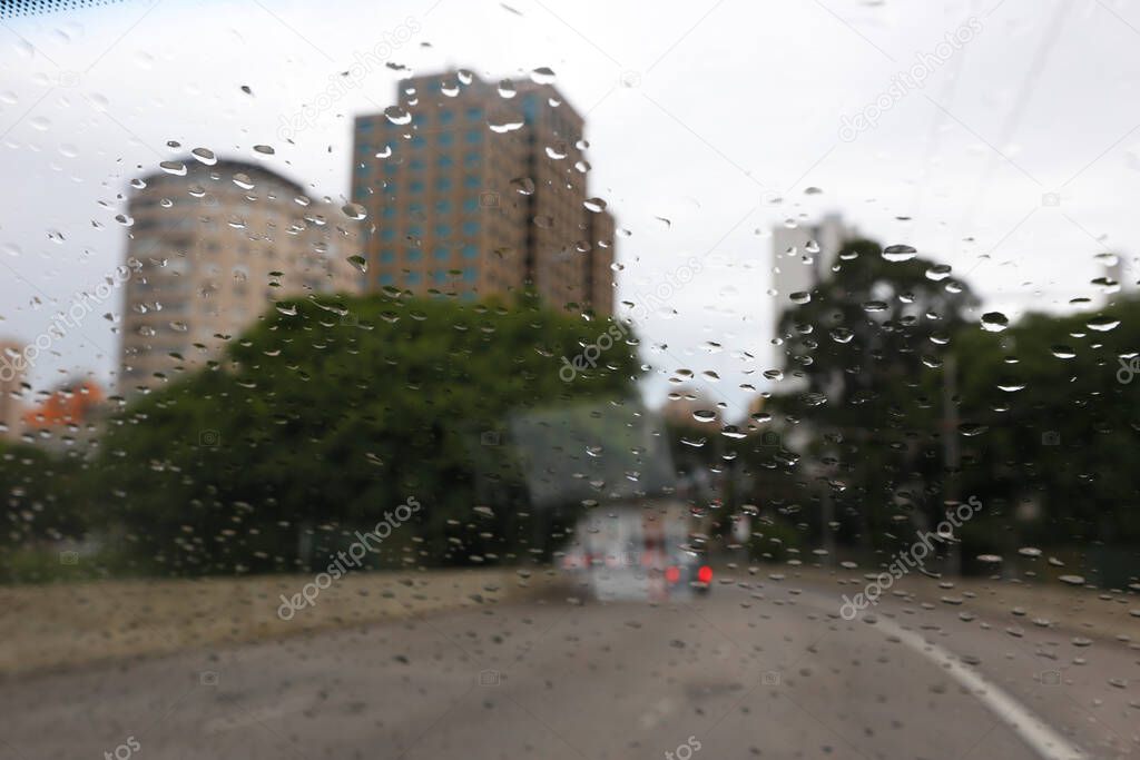 View of city in rainy day, from car windshield, with water drops. Sao Paulo city, Brazil