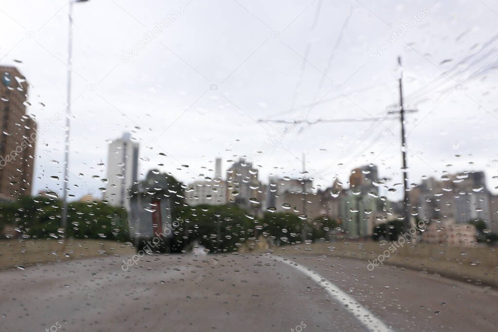 View of city in rainy day, from car windshield, with water drops. Sao Paulo city, Brazil