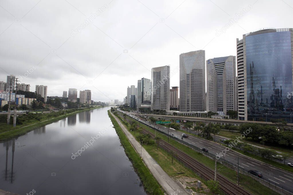 Buildings of Marginal Pinheiros reflected in the waters of the Pinheiros river, on a rainy day. Sao Paulo. Brazil