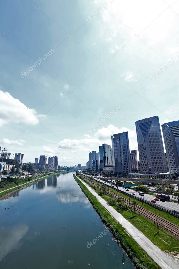 Urban landscape with river, marginal roads, cars and buildings. Marginal Pinheiros, Sao Paulo, Brazil