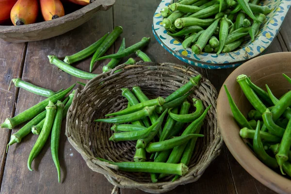 Portion Freshly Picked Okra Bowls Different Materials Rustic Wooden Table — Stock Photo, Image