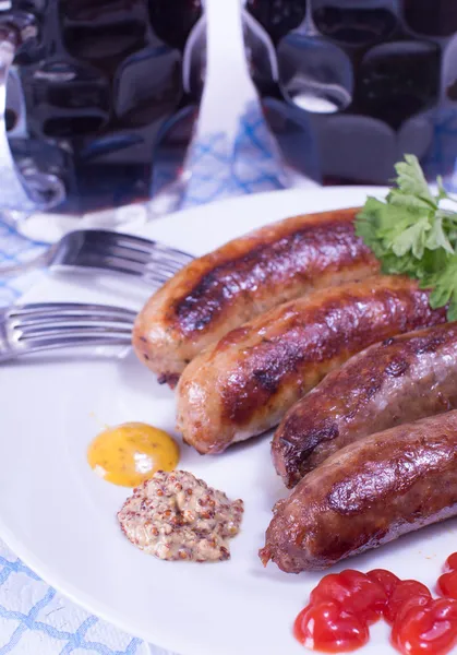 Beer and sausages on a plate — Stock Photo, Image