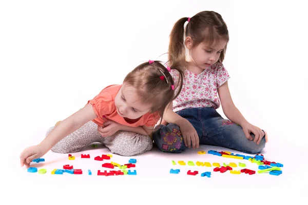 Girls playing with alphabet — Stock Photo, Image