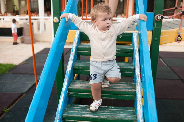 Happy little boy walking up on ladder — Stock Photo, Image