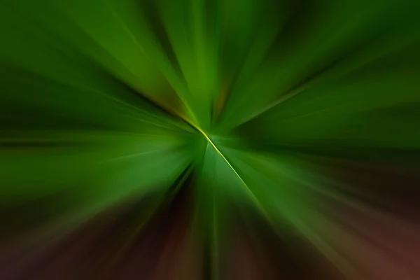 Saturated dark green and red motion blur with narrow yellow beam in the center — Stockfoto
