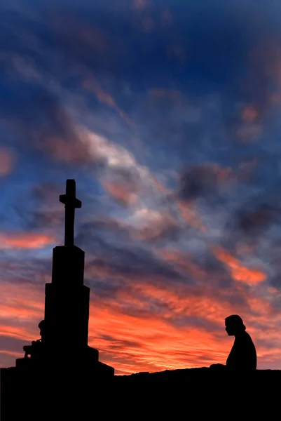 Cross with a person against the sky — Stock Photo, Image