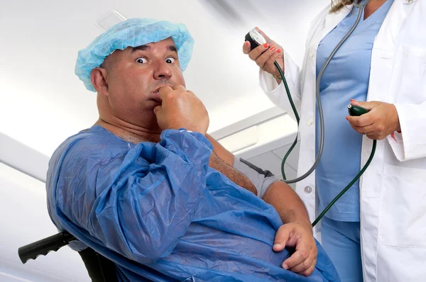 Large male patient in a wheelchair with doctor — Stock Photo, Image