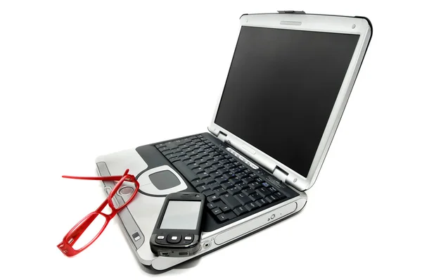 Laptop with mobile and glasses — Stock Photo, Image