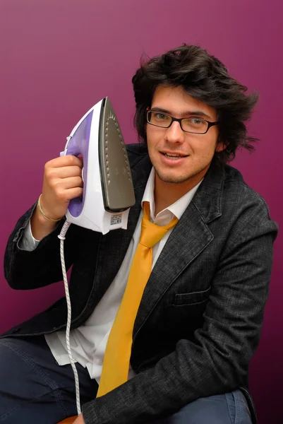 Young man with iron — Stock Photo, Image