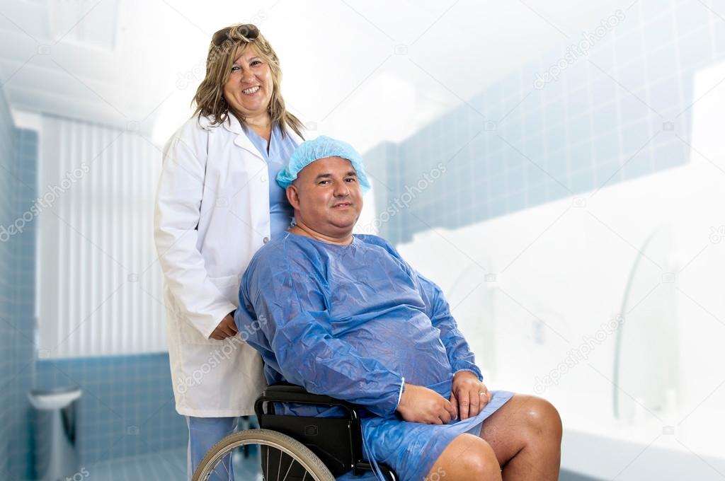 Large male patient in a wheelchair with doctor