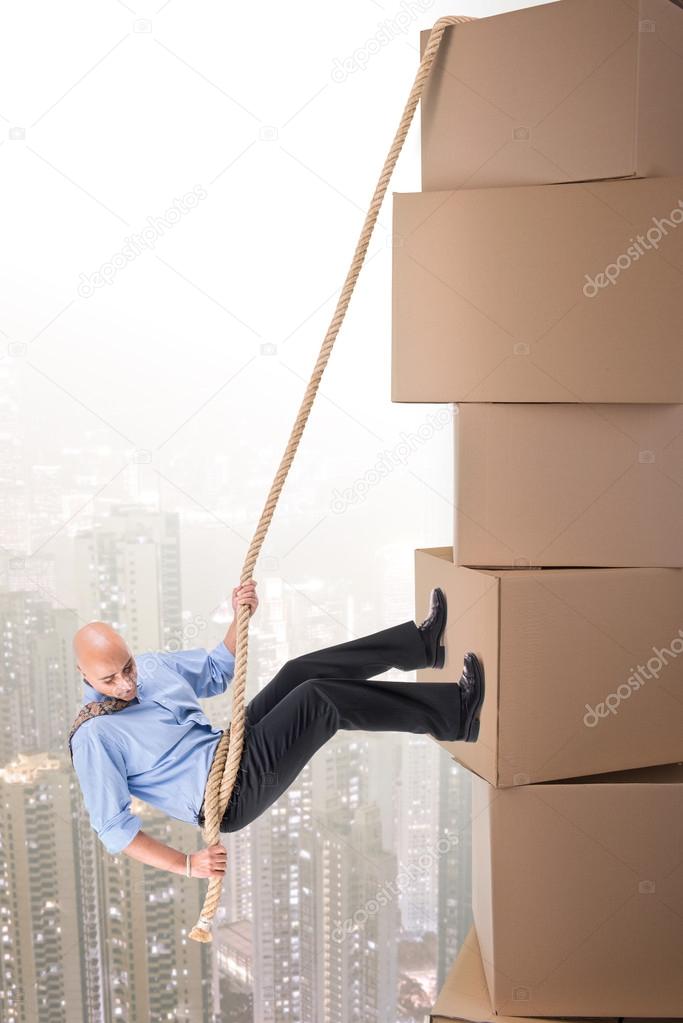 Businessman climbing boxes
