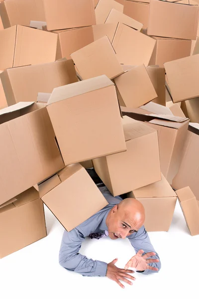 Businessman under boxes — Stock Photo, Image