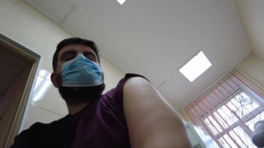Kyiv, Ukrayna, Avrupa - Kasım 2021: Doktor Covid-19 aşısı yaptı. Doktor aşıyı bir enjeksiyon yapar. Klinikte planlanmış aşı.