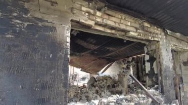 Gorenka, Kyiv region, Ukraine - July 2022: Local residents are clearing the rubble of a destroyed house. Consequences of the war between Russia and Ukraine. Destroyed houses after the bombing of the R