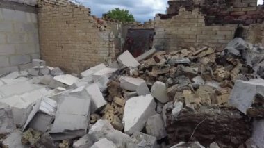 Gorenka, Kyiv region, Ukraine - July 2022: Local residents are clearing the rubble of a destroyed house. Consequences of the war between Russia and Ukraine. Destroyed houses after the bombing of the R