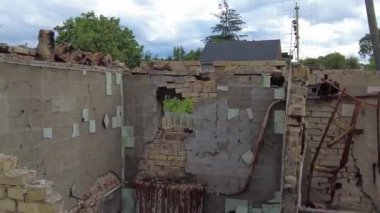 Gorenka, Kyiv region, Ukraine - July 2022: Local residents are clearing the rubble of a destroyed house. Consequences of the war between Russia and Ukraine. Destroyed houses after the bombing of the R