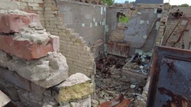 Gorenka, Kyiv region, Ukraine - July 2022: Local residents are clearing the rubble of a destroyed house. Consequences of the war between Russia and Ukraine. Destroyed houses after the bombing of the R