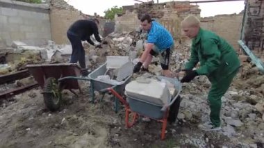 Gorenka, Kyiv region, Ukraine - July 2022: Local residents are clearing the rubble of a destroyed house. Consequences of the war between Russia and Ukraine. Destroyed houses after the bombing of the R